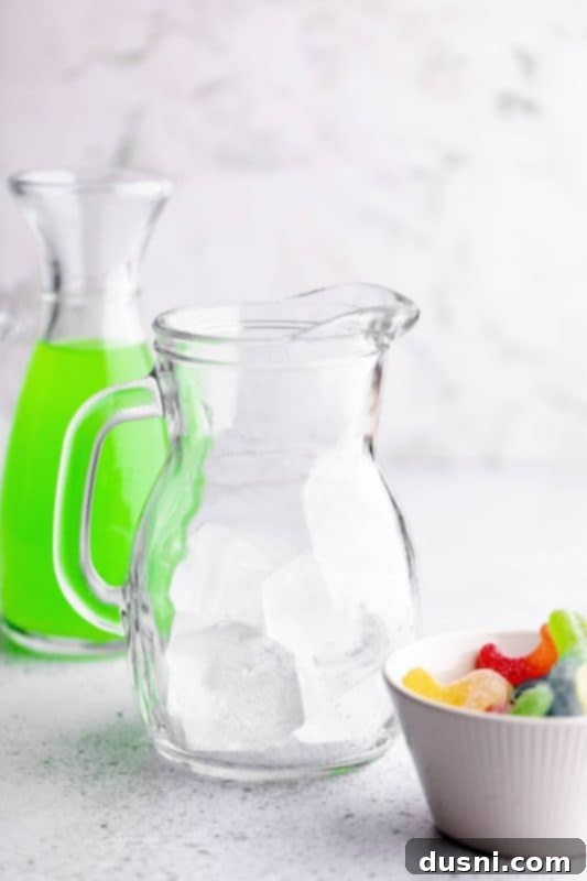 Pitcher with ice and sour worms for Halloween Punch