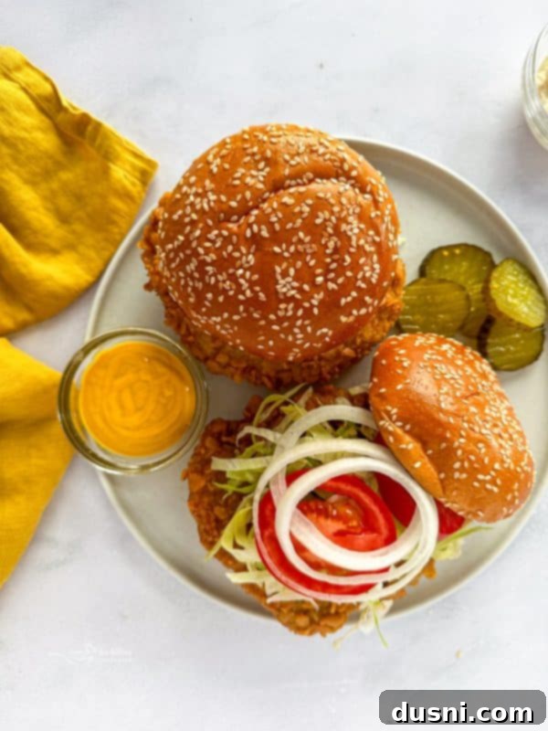 Tenderloin Crunchwich 15 Another appealing shot of a Breaded Pork Tenderloin Sandwich on a plate with fries.