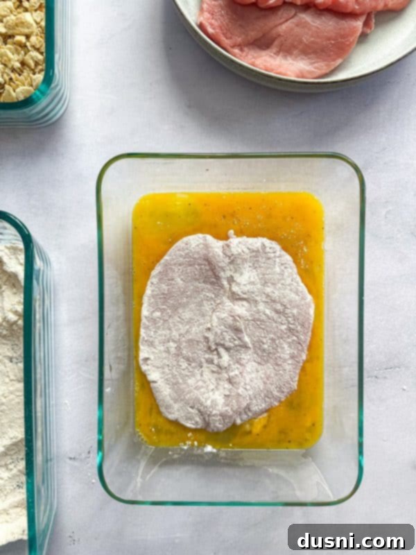 Tenderloin Crunchwich 9 Three dishes set up for a breading station: flour, egg wash, and cracker crumbs.