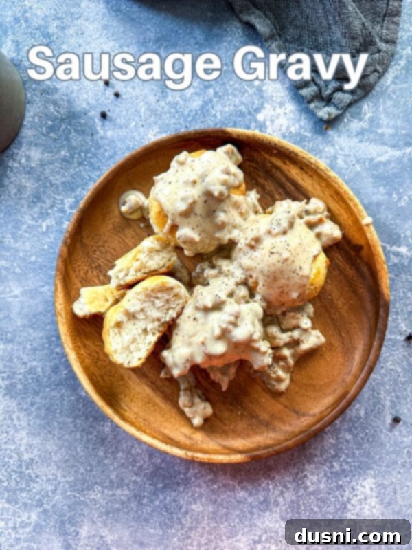 A final close-up shot of the rich, creamy homemade sausage gravy in a bowl, with a spoon for serving.