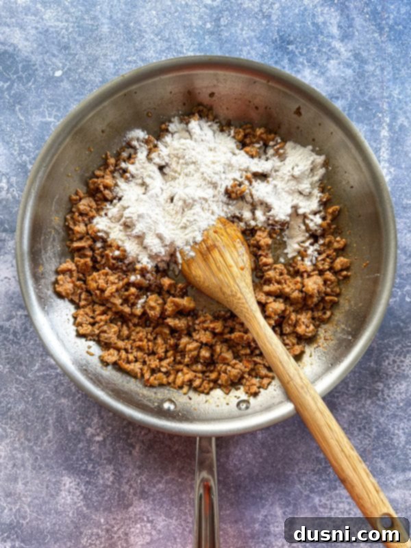 Step 1: Browning ground pork sausage in a large skillet over medium-high heat until golden brown.