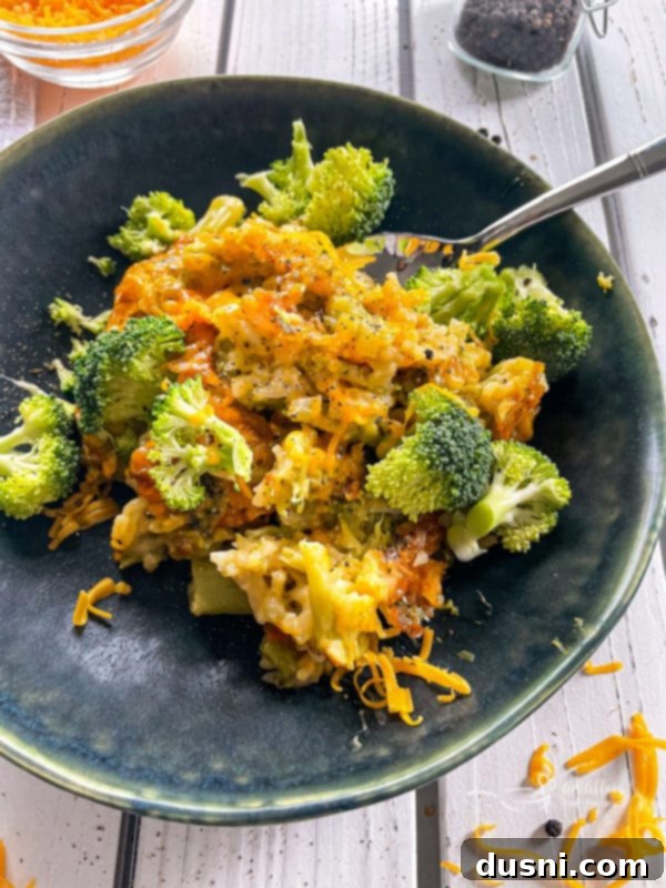 Top view of broccoli, rice, and cheese casserole on top of dark plate