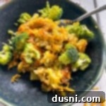 Cheesy Broccoli Rice Comfort Bake 14 Top view of broccoli, rice, and cheese casserole on top of dark plate