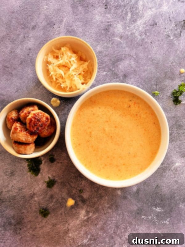 Alsatian Choucroute Soup 16 A beautifully plated bowl of French Sauerkraut Soup with bratwurst and parsley.