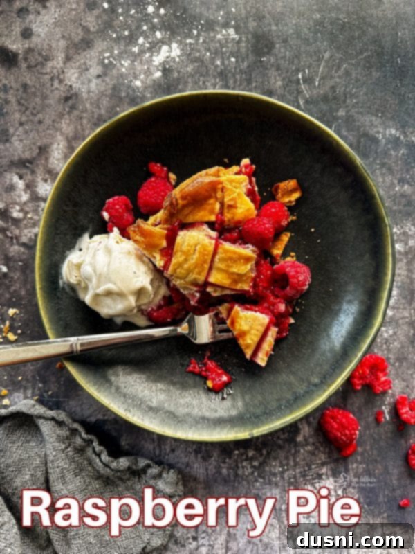 Sun-Kissed Raspberry Pie 17 Beautiful homemade fresh raspberry pie with a lattice top, golden brown crust, and vibrant red filling visible through the lattice.