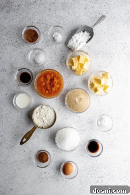 Several frosted pumpkin cookies on a cooling rack