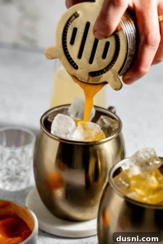 Step 8: Strain the shaken cocktail mixture over ice.