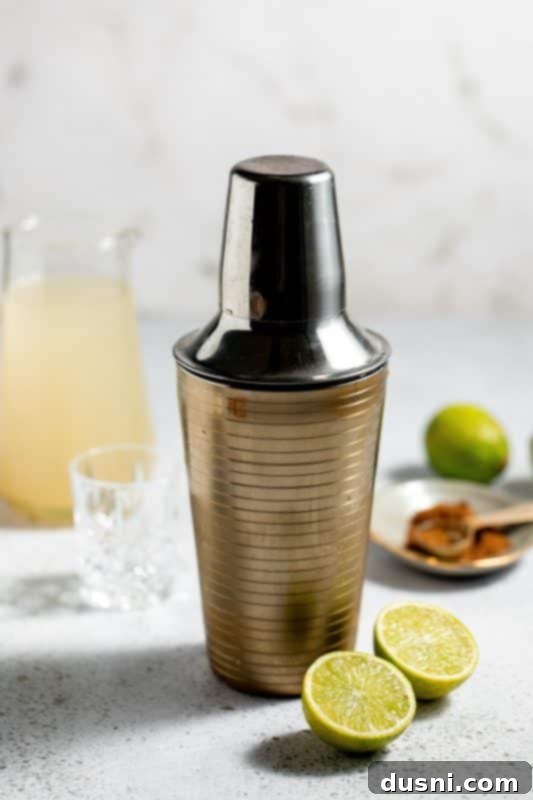 Step 6: Shake the cocktail ingredients.