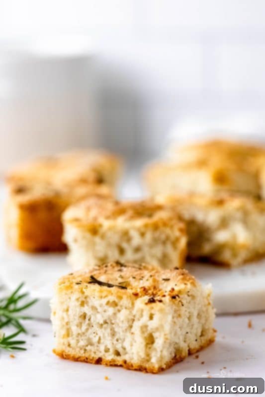 Close-up of a slice of golden-brown Garlic Rosemary Focaccia Bread