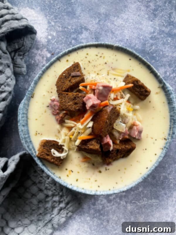 Zesty Mexican Leftover Turkey Soup 15 Cream of Reuben Soup in a grey pottery bowl with rye croutons