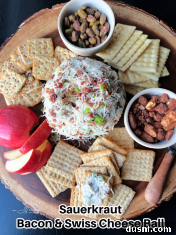 A final hero shot of the Sauerkraut Bacon & Swiss Cheese Ball, beautifully garnished and ready to be served at a party.