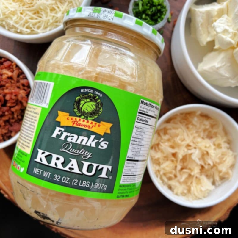 Another perspective of the cheese ball, focusing on the fresh green onion and chive garnishes, with crackers ready for dipping.