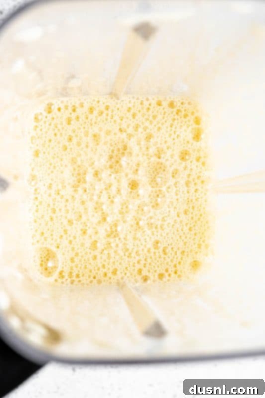 Homemade Blender Eggnog 9 Blender operating, mixing eggs and maple syrup to a frothy consistency.