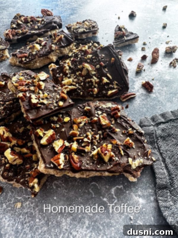 Classic Handcrafted Toffee 14 Large pieces of homemade toffee on a wooden board, with more in the background.