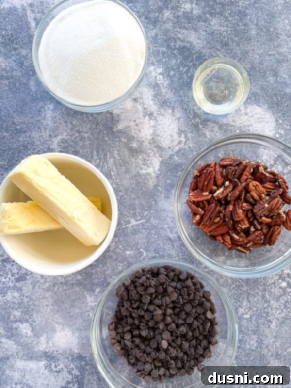 Classic Handcrafted Toffee 5 Several pieces of chocolate-covered toffee with pecans, artfully stacked.