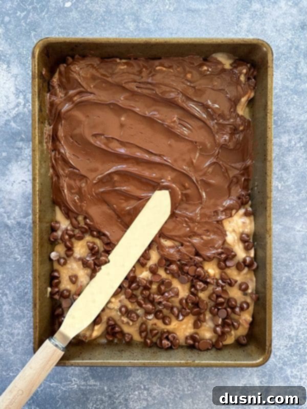 Classic Handcrafted Toffee 8 Melted chocolate spread over toffee in a baking pan.