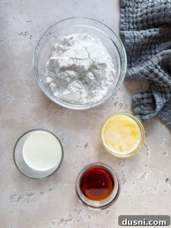 Close-up of cookie dough in a mixing bowl with ingredients on the side