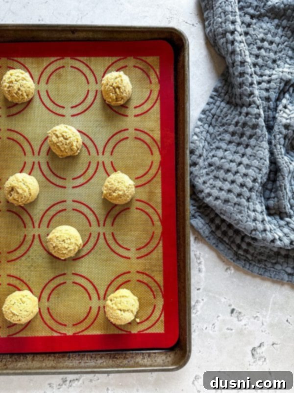 Freshly baked maple sugar cookies cooling on a wire rack after being removed from the oven