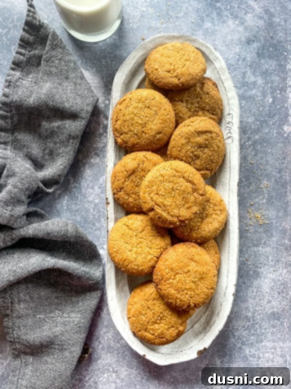 Chewy Brown Sugar Delights 12 A close-up shot of a single brown sugar cookie, with a bite taken out, revealing its soft and chewy interior texture.