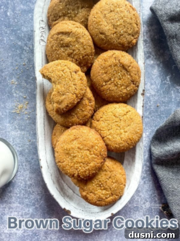 Chewy Brown Sugar Delights 16 A hero shot of freshly baked brown sugar cookies on a cooling rack, with one cookie in the foreground, perfect for a cozy treat.