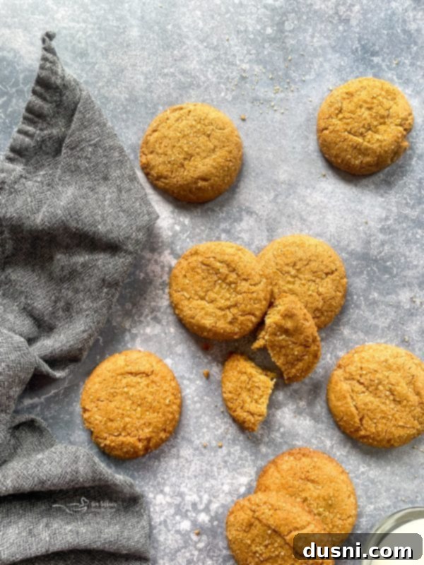Chewy Brown Sugar Delights 3 A close-up of a single brown sugar cookie on a cooling rack, showing its perfectly baked texture and glistening sugar crystals.