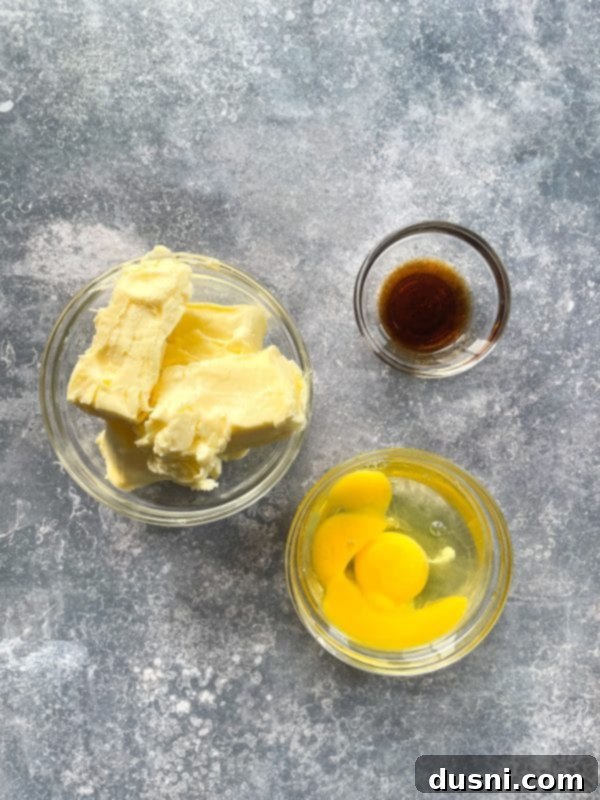 Chewy Brown Sugar Delights 5 Various baking ingredients laid out on a kitchen counter: flour, brown sugar, eggs, butter, and vanilla extract, ready for mixing.