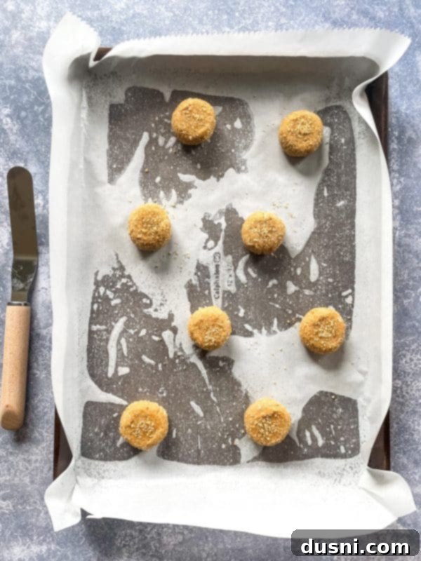 Chewy Brown Sugar Delights 9 Cookie dough balls rolled in sugar crystals on a parchment-lined baking sheet.
