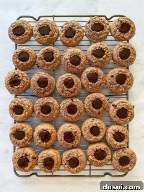 Hot Cocoa Thumbprint Delights 12 Spoon melted chocolate ganache into the center of each cookie.