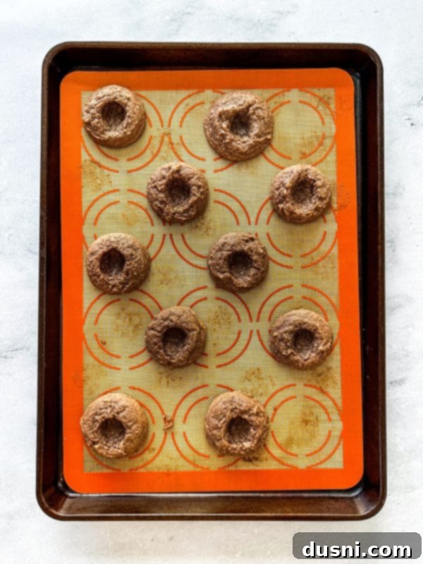 Hot Cocoa Thumbprint Delights 9 Making thumbprint indentations in freshly baked cookies.