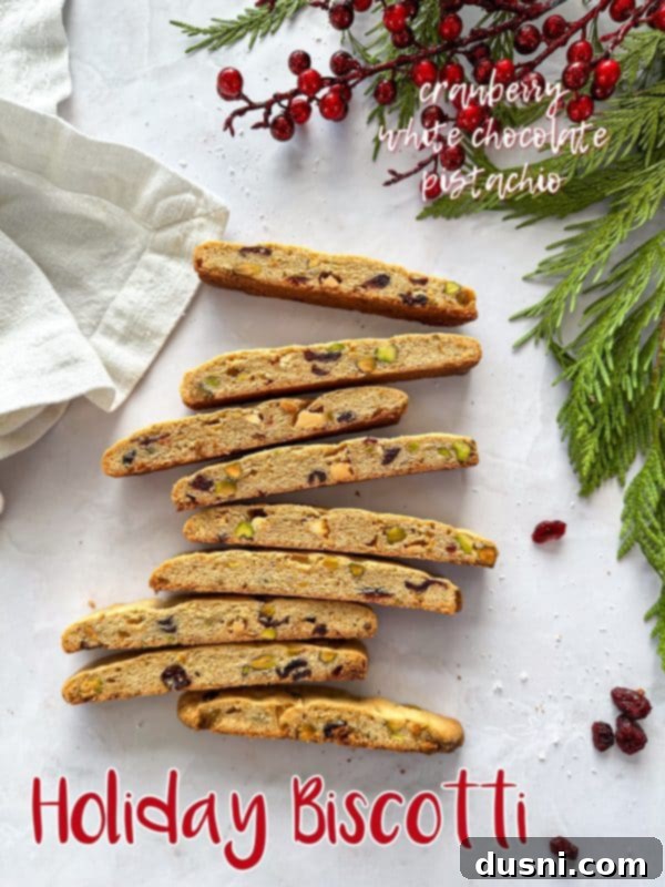 Large image of Holiday Biscotti, some dipped in white chocolate with pistachios.