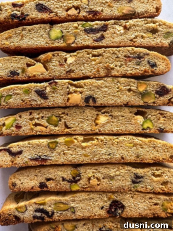 Freshly baked Holiday Biscotti logs on a baking sheet before slicing.