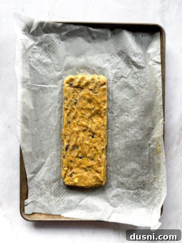 Biscotti dough with cranberries, pistachios, and white chocolate folded in.