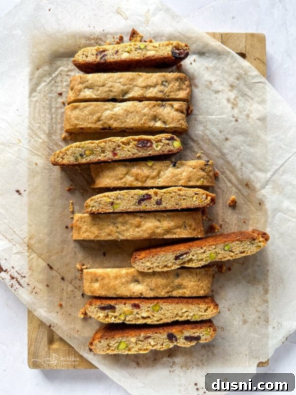 Sliced biscotti pieces on a cutting board, ready for second bake.
