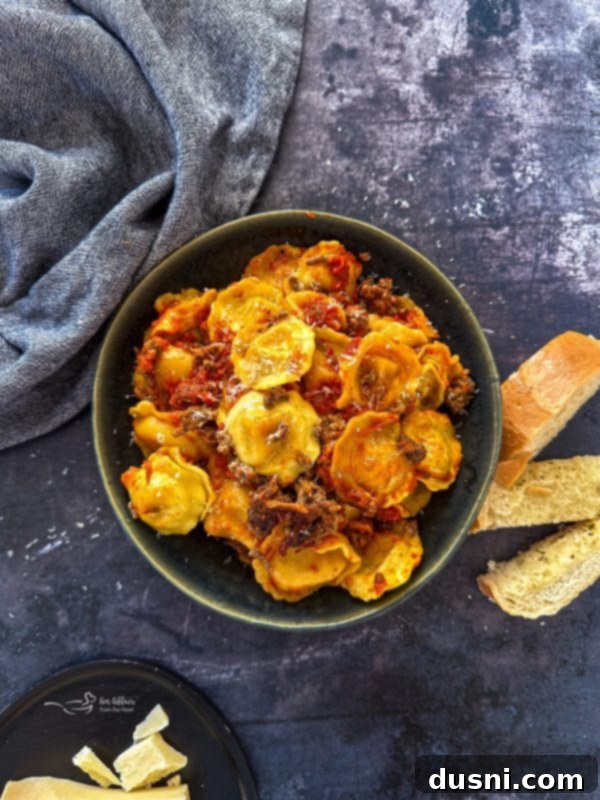 Lazy Slow Cooker Ravioli Lasagna 14 Side view of a serving of Slow Cooker Ravioli Lasagna, highlighting the tender pasta and cheese.