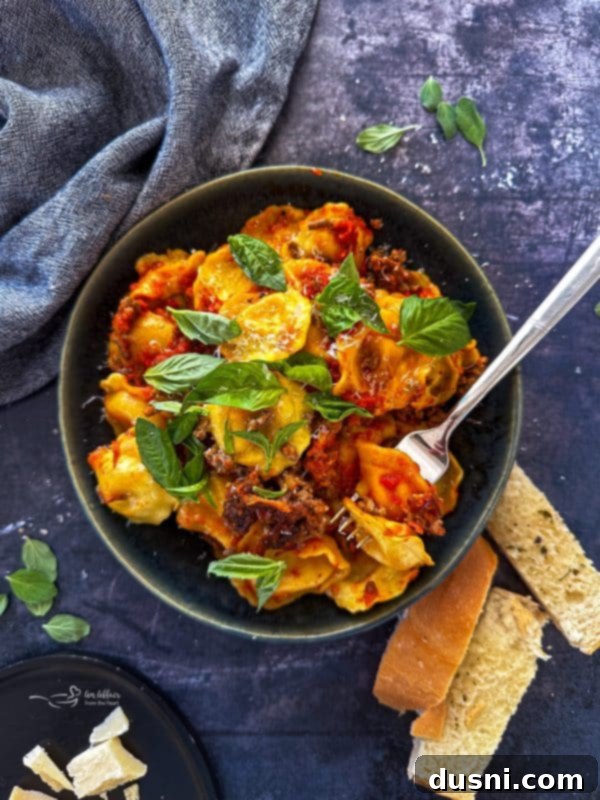 Lazy Slow Cooker Ravioli Lasagna 6 Close up on a single serving of Slow Cooker Ravioli Lasagna with a fork.