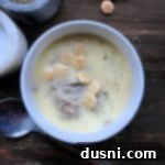 Velvety Oyster Stew 16 Oyster stew topped with oyster crackers in a white bowl