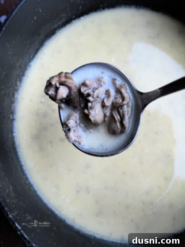 Velvety Oyster Stew 4 A beautifully garnished bowl of classic oyster stew, perfect for a festive gathering.
