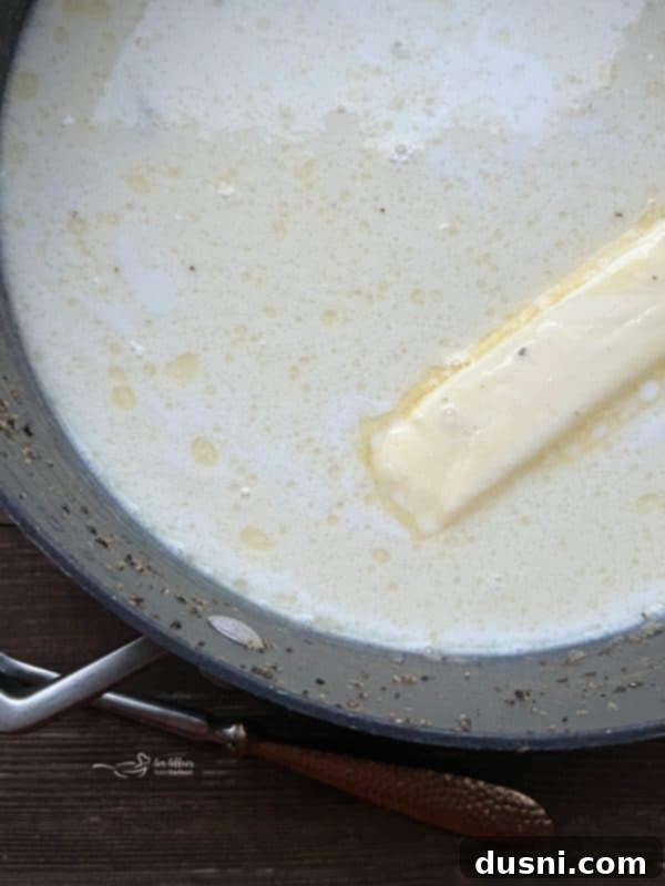 Velvety Oyster Stew 10 Pouring milk into the oyster and butter mixture to create a creamy, comforting stew.