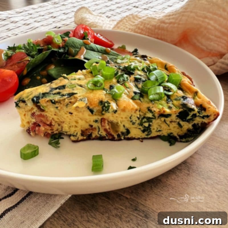 Dorothy's Hearty Bacon & Potato Frittata 15 Close-up of a frittata slice on a plate, garnished with green onions and parsley