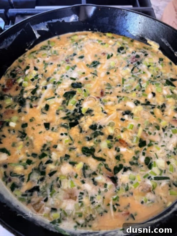 Dorothy's Hearty Bacon & Potato Frittata 9 Bowl of whisked egg mixture with cheese, herbs, and Dorothy Lynch dressing
