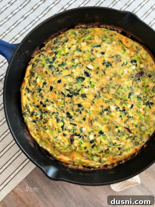 Dorothy's Hearty Bacon & Potato Frittata 10 Egg mixture poured over bacon and potatoes in a cast iron skillet, cooking on the stove