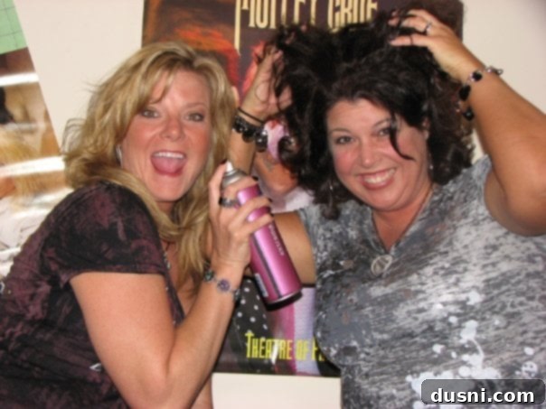 Michaela and Candi smiling and posing playfully before a Motley Crue concert.