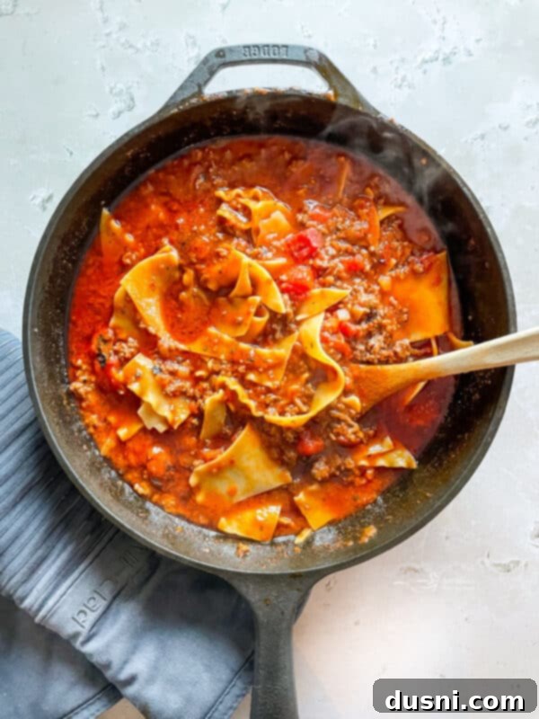 Skillet lasagna simmering with noodles and sauce