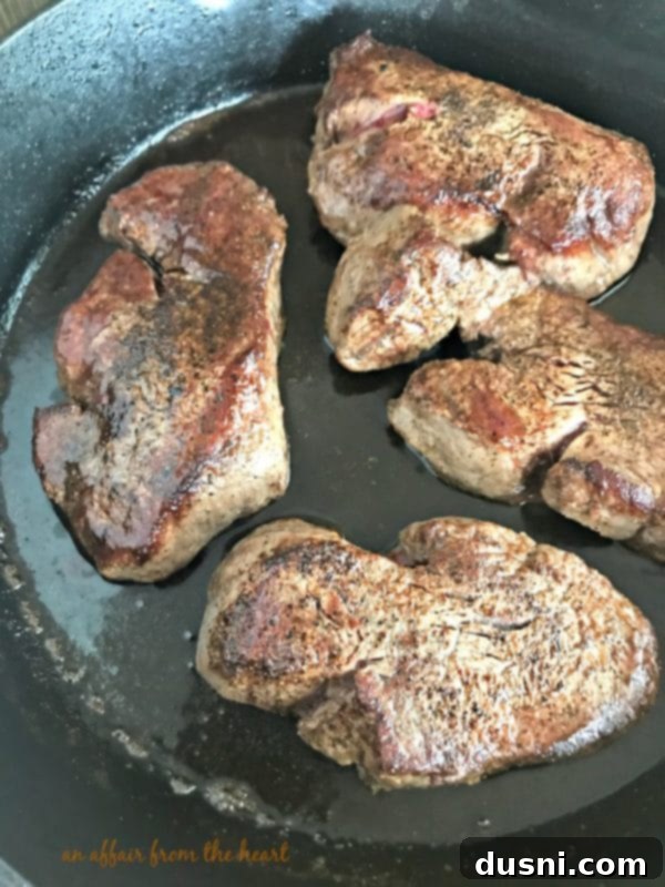 Gourmet Herb Butter Filet Mignon 6 Cooked Filet Mignon steaks resting on a plate, covered with foil.