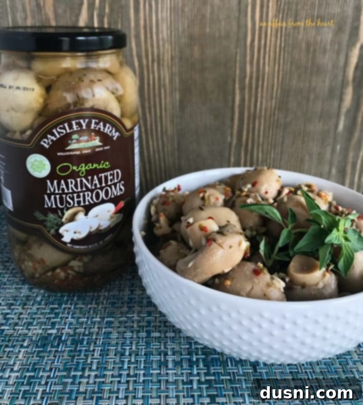 Gourmet Herb Butter Filet Mignon 8 A bowl of Paisley Farm Organic Marinated Mushrooms, a perfect accompaniment to Filet Mignon.