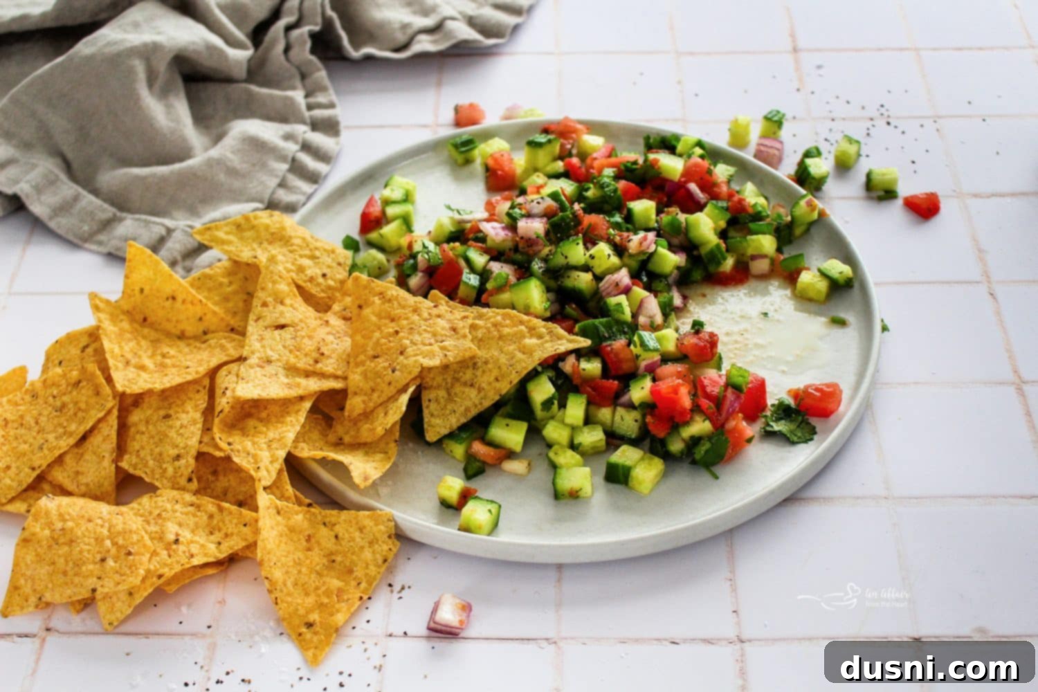 Cucumber salsa in a rustic white bowl, ready to be served.
