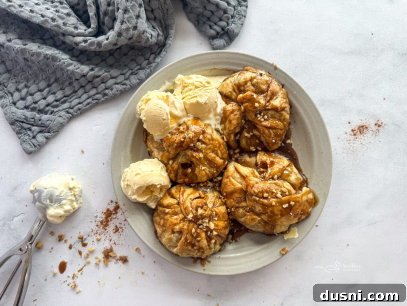 Pouring Spiced Rum Caramel Sauce over Apple Dumplings