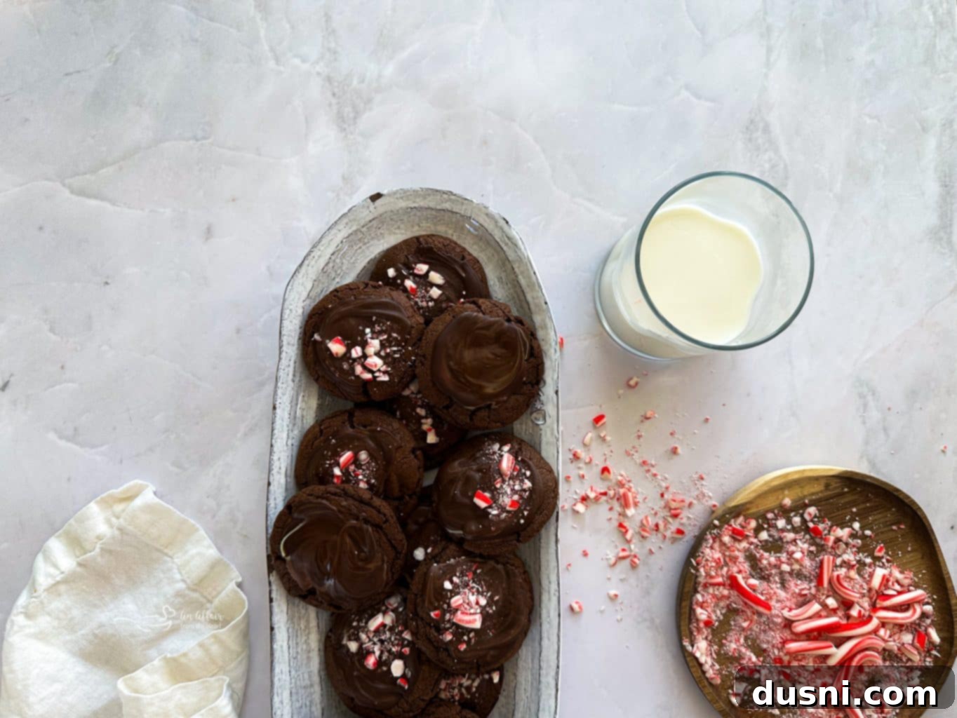 Mint Chocolate Cookie Delights 6 A generous pile of Chocolate Mint Candy Cookies on a cooling rack, fresh out of the oven.