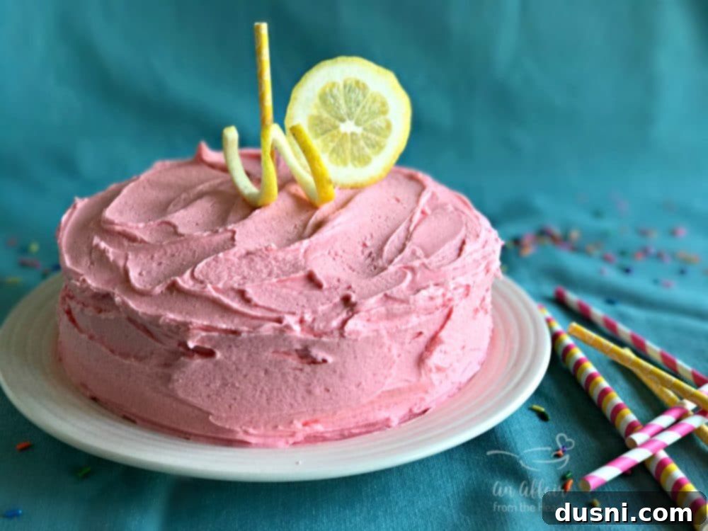 Blush Citrus Dream 2 Pink Lemonade Cake sliced on a serving plate