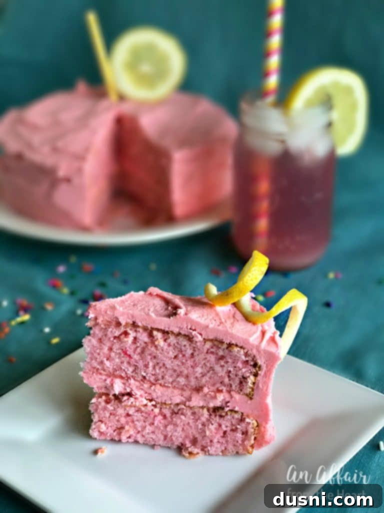 Blush Citrus Dream 16 Pink Lemonade Cake with lemon slices and mint on a white pedestal